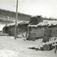 Engan, Os, Nord Østerdal, Hedmark 1937. Vinterbilde av fjøs og løe, litt av låvebru fremst i bildet.