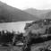 Kravik, Nore, Nore og Uvdal. 1930. Oversiktsbilde. Utsikt mot gården omgitt av jorder og skog. Vann. Fjell i bakgrunnen.