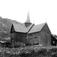 Nore stavkirke, Nore og Uvdal, Numedal, Buskerud. 1930. Kirkegård. Gravkors. Bebyggelse. Gårder, skog og åser i bakgrunnen.