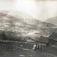 Gårdstun, Øvre Åbø , Hjartdal, Telemark. Fotografert 1915. Familie stående foran stabbur med landskap i bakgrunn.