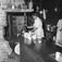 Finnskogen, august 1956. Marken. Interiør, kjøkken, kvinne med kaffestell.